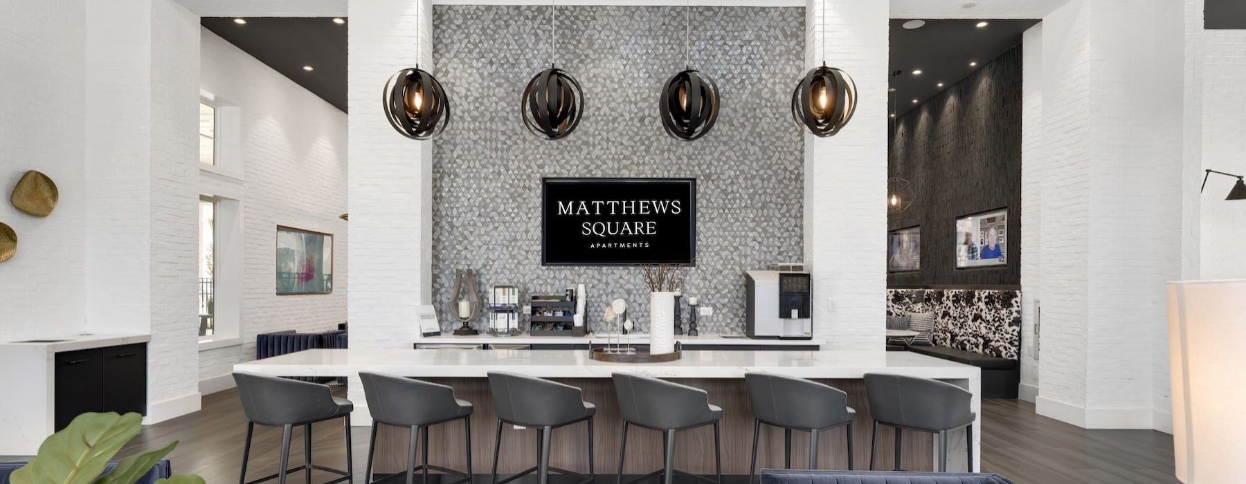 a large community kitchen with seating and a tv