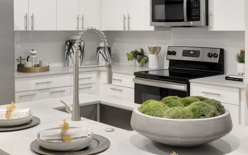 sink and dining island in bright kitchen