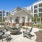 chairs surround fire pit next to covered kitchen area and grills