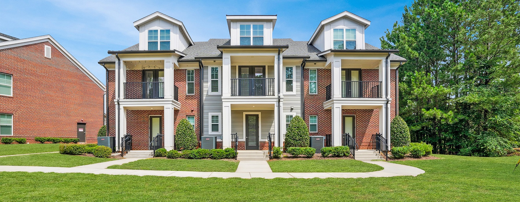a townhome with a green lawn