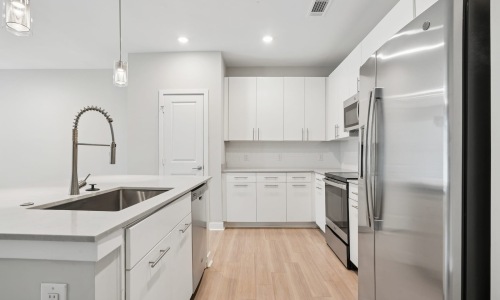 Kitchen with an island kitchen with ample counter-space and modern appliances
